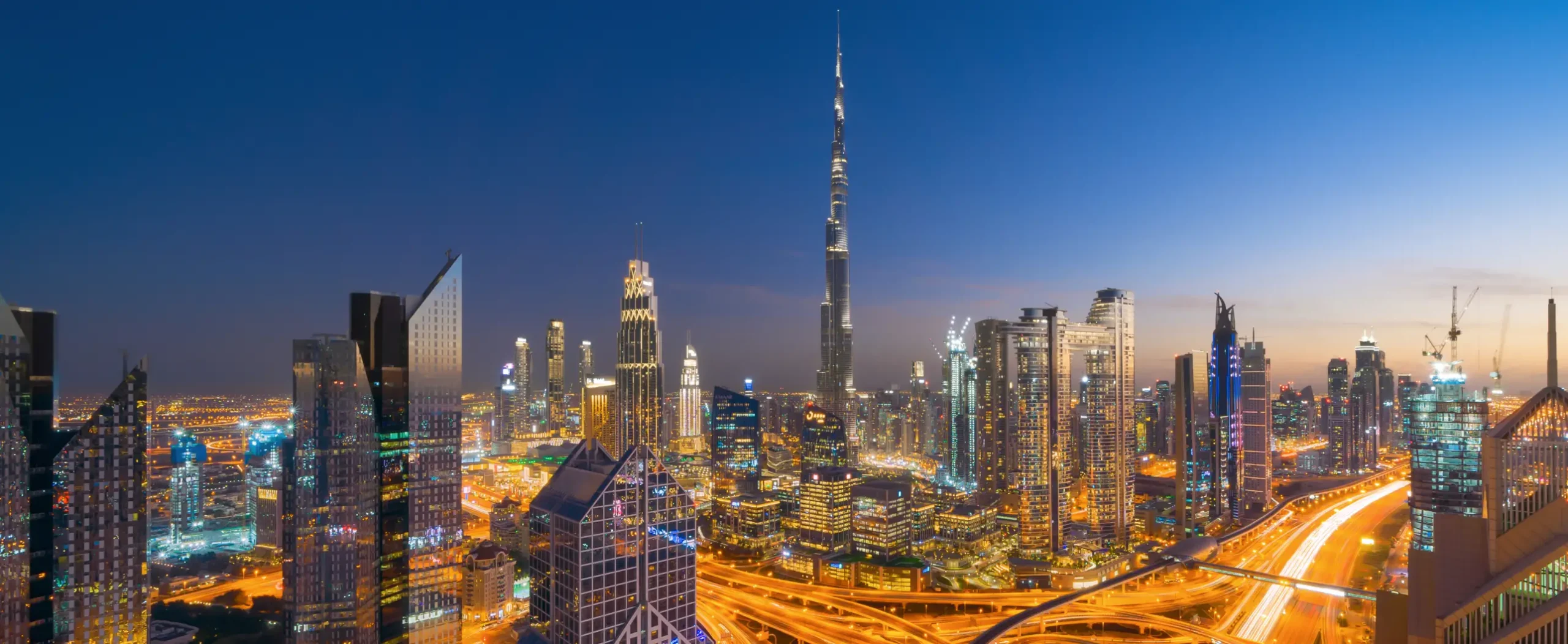 Dubai skyline with the Burj Khalifa and highway light trails