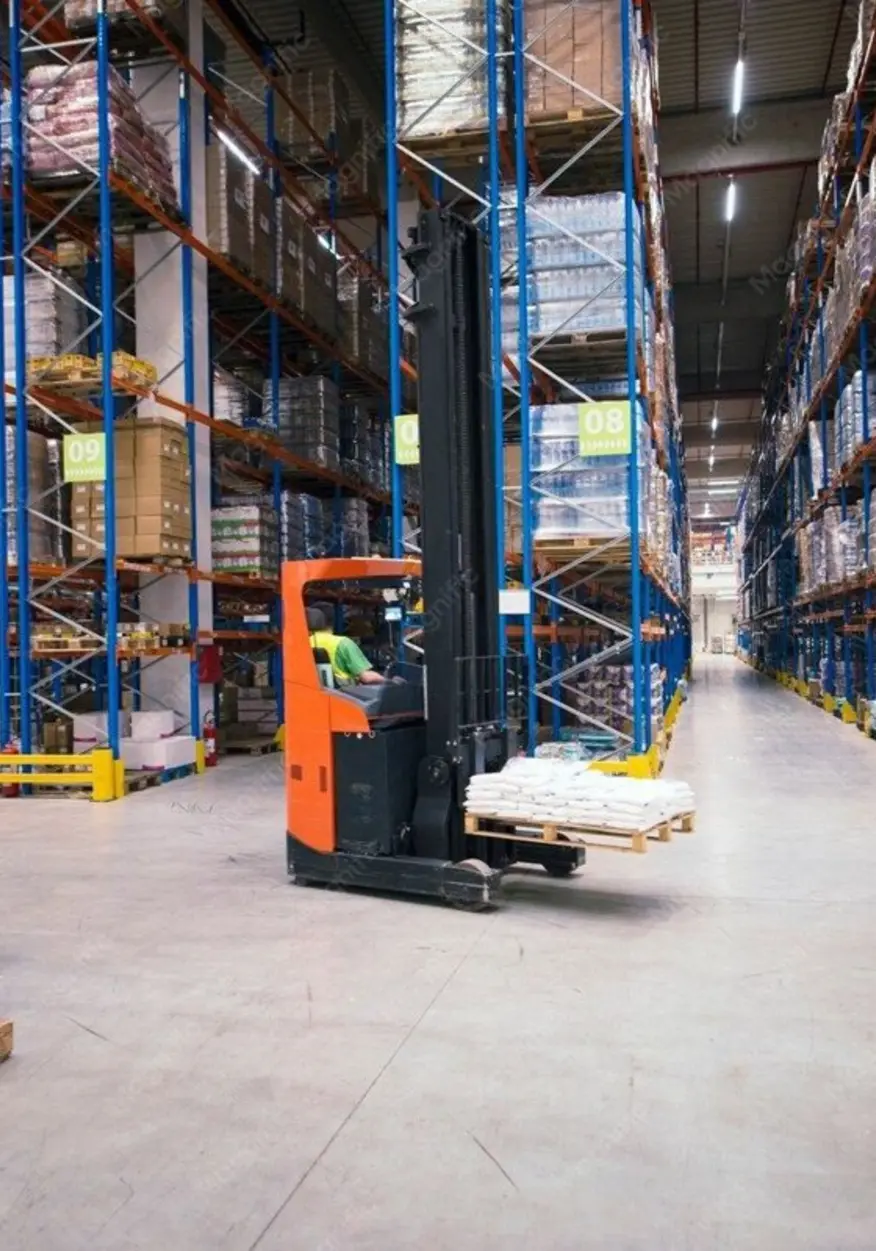 Reach truck in a high-bay warehouse